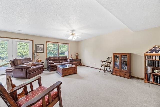 2215 Balsam Ct, Iowa City, IA 52240 - living area with a ceiling fan, a textured ceiling, and light carpet