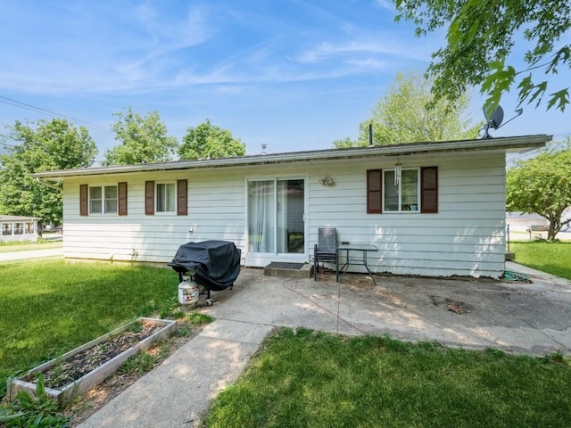 304 3rd St S, Coggon, IA 52218 - rear view of property featuring a yard, a patio area, and a vegetable garden