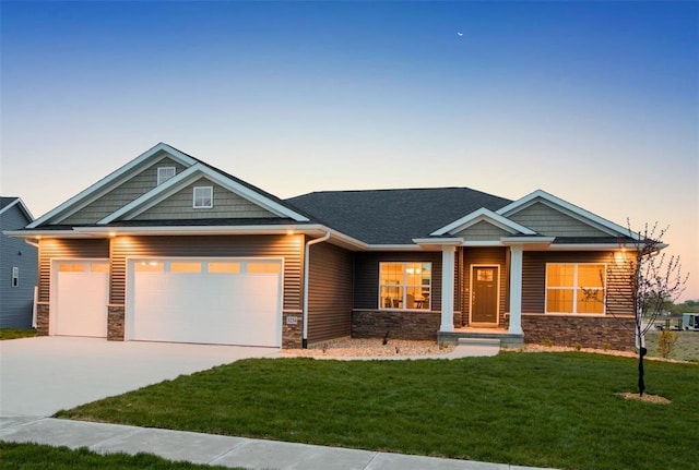 5503 Seminole Valley Trl NE, Cedar Rapids, IA 52411 - craftsman house featuring stone siding, a garage, a lawn, and driveway