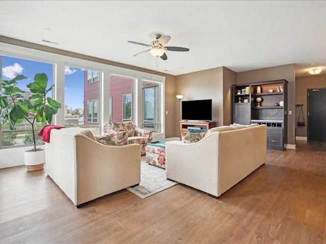 100 4th Ave SW Unit 204, Cedar Rapids, IA 52404 - living room with light wood finished floors and ceiling fan