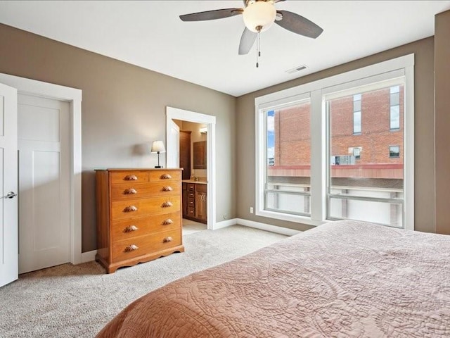 100 4th Ave SW Unit 204, Cedar Rapids, IA 52404 - carpeted bedroom featuring connected bathroom and a ceiling fan
