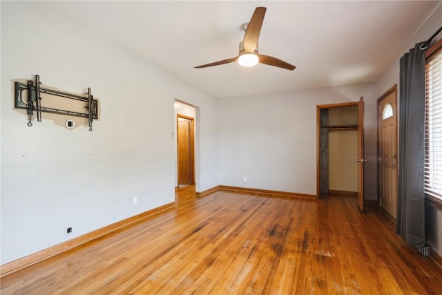 2901 J St SW, Cedar Rapids, IA 52404 - unfurnished bedroom with light wood-style flooring, multiple windows, and a ceiling fan