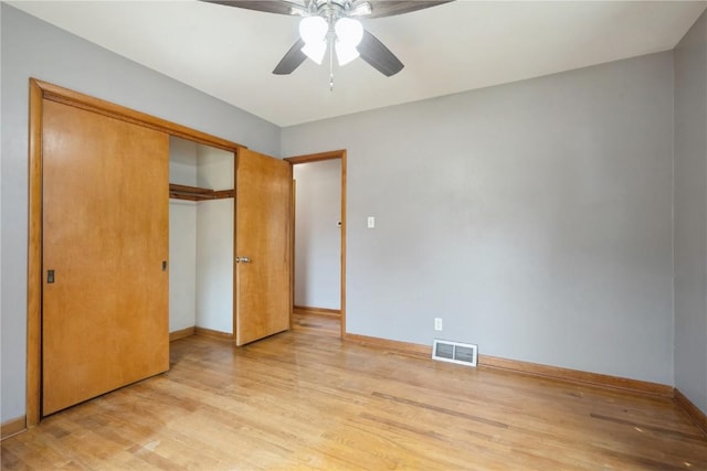 2901 J St SW, Cedar Rapids, IA 52404 - unfurnished bedroom with light wood finished floors, a closet, and ceiling fan