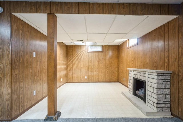 2901 J St SW, Cedar Rapids, IA 52404 - below grade area with light floors, wood walls, a fireplace, and a drop ceiling