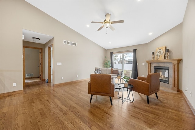 345 Shannon Dr, Robins, IA 52328 - living area with lofted ceiling, ceiling fan, light wood-style floors, a tile fireplace, and recessed lighting
