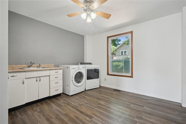 1802 9th Ave, Belle Plaine, IA 52208 - washroom featuring washer and dryer, dark wood-style floors, cabinet space, and ceiling fan