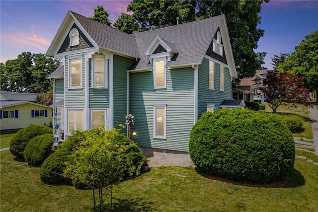 1802 9th Ave, Belle Plaine, IA 52208 - view of front of house featuring a front lawn and a shingled roof