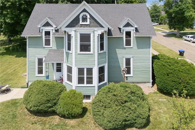1802 9th Ave, Belle Plaine, IA 52208 - back of house with a lawn, roof with shingles, and a patio area