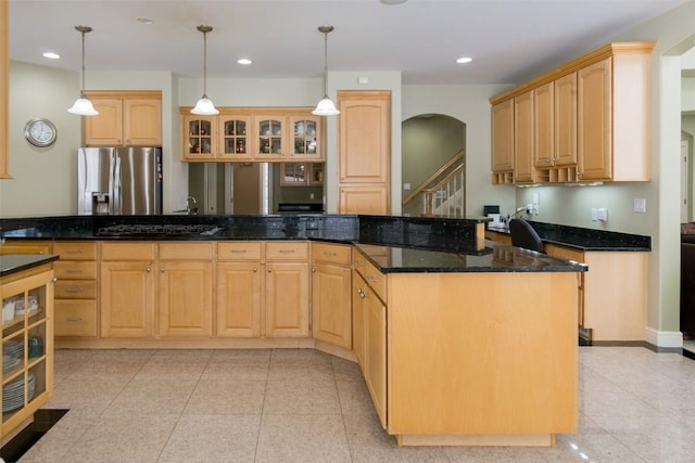 4402 Oak Leaf Ct NE, Cedar Rapids, IA 52411 - kitchen with stainless steel fridge, light brown cabinets, arched walkways, glass insert cabinets, and dark stone counters