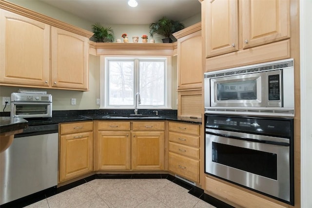 4402 Oak Leaf Ct NE, Cedar Rapids, IA 52411 - kitchen featuring appliances with stainless steel finishes, light brown cabinetry, and dark stone counters