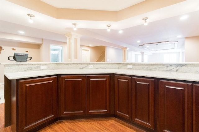 4402 Oak Leaf Ct NE, Cedar Rapids, IA 52411 - kitchen featuring light wood-type flooring and light stone counters