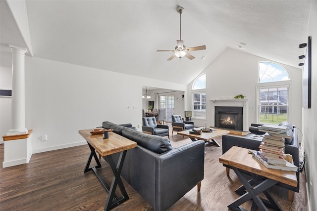 429 W Prairie Dr, Fairfax, IA 52228 - living area with decorative columns, a ceiling fan, high vaulted ceiling, dark wood-style floors, and a glass covered fireplace