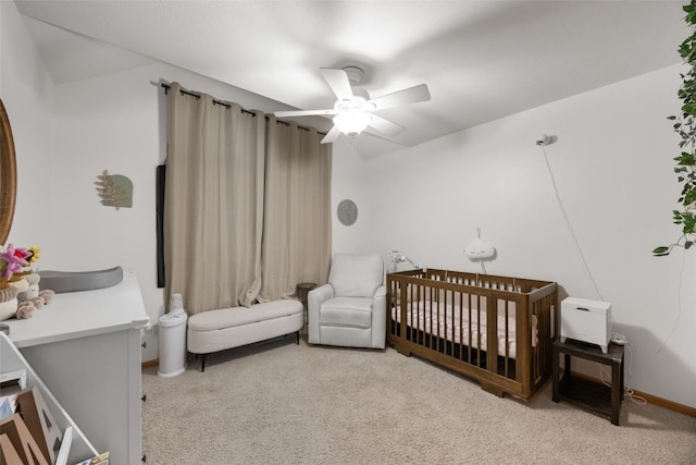 429 W Prairie Dr, Fairfax, IA 52228 - bedroom featuring carpet floors, a crib, and ceiling fan