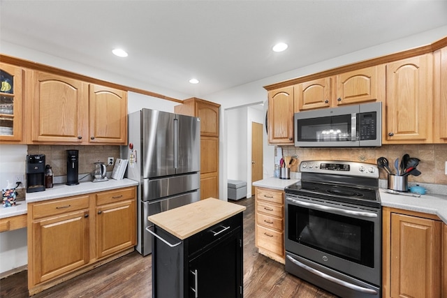 429 W Prairie Dr, Fairfax, IA 52228 - kitchen featuring stainless steel appliances, backsplash, glass insert cabinets, dark wood-style floors, and recessed lighting