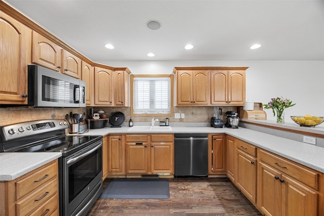 429 W Prairie Dr, Fairfax, IA 52228 - kitchen featuring stainless steel appliances, tasteful backsplash, dark wood-style floors, recessed lighting, and light countertops