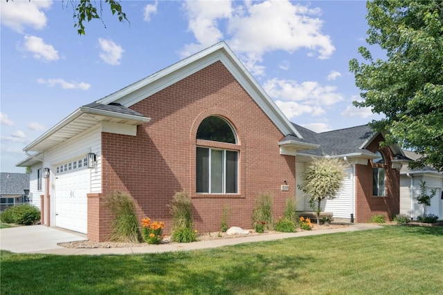 310 34th Ave, Marion, IA 52302 - view of front of property featuring brick siding, a front yard, a garage, and driveway