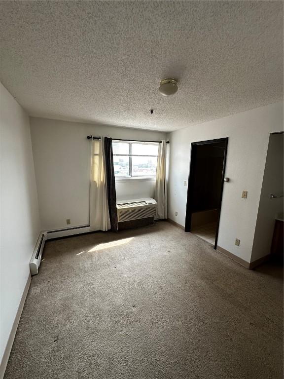 400 1st St SE Unit 410, Cedar Rapids, IA 52401 - unfurnished bedroom with carpet floors and a textured ceiling
