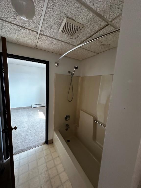 400 1st St SE Unit 410, Cedar Rapids, IA 52401 - bathroom with tile patterned floors,  shower combination, and baseboard heating