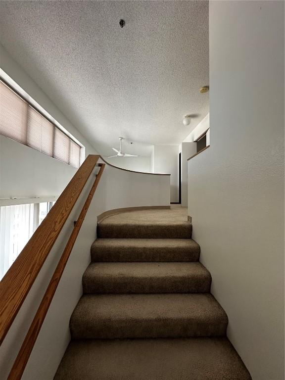 400 1st St SE Unit 410, Cedar Rapids, IA 52401 - staircase with a textured ceiling