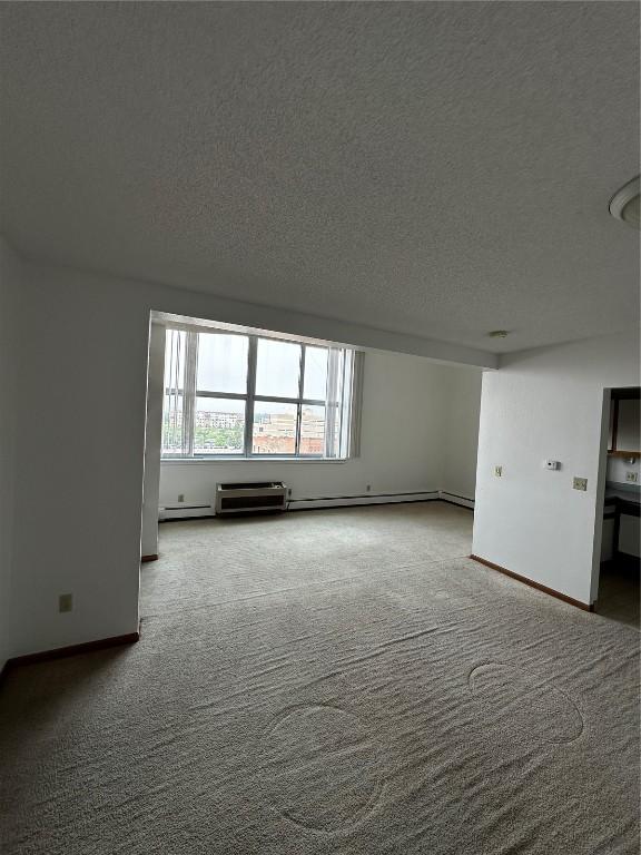 400 1st St SE Unit 410, Cedar Rapids, IA 52401 - carpeted spare room featuring a textured ceiling