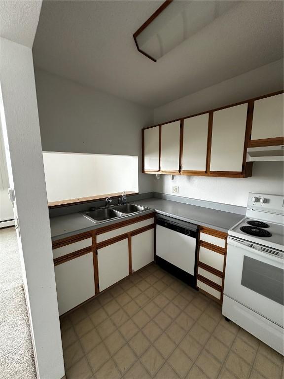 400 1st St SE Unit 410, Cedar Rapids, IA 52401 - kitchen with white appliances, under cabinet range hood, white cabinets, and dark countertops