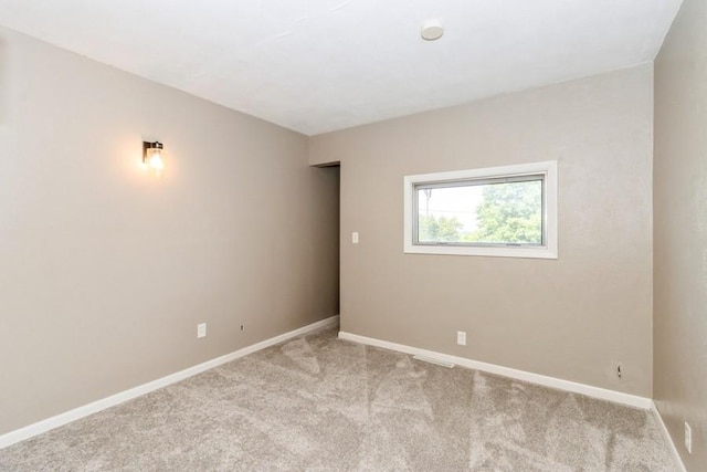2175 Chandler St SW, Cedar Rapids, IA 52404 - spare room featuring light colored carpet and baseboards