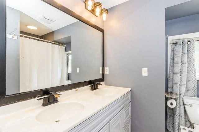 2175 Chandler St SW, Cedar Rapids, IA 52404 - bathroom featuring toilet and double vanity