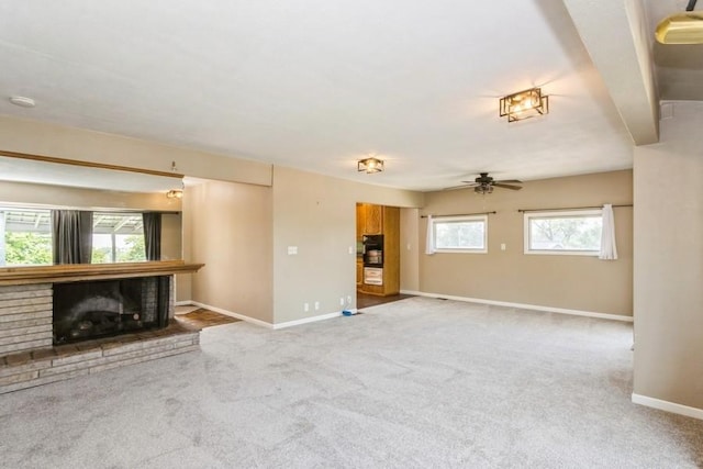 2175 Chandler St SW, Cedar Rapids, IA 52404 - unfurnished living room featuring carpet floors, a fireplace, and a ceiling fan