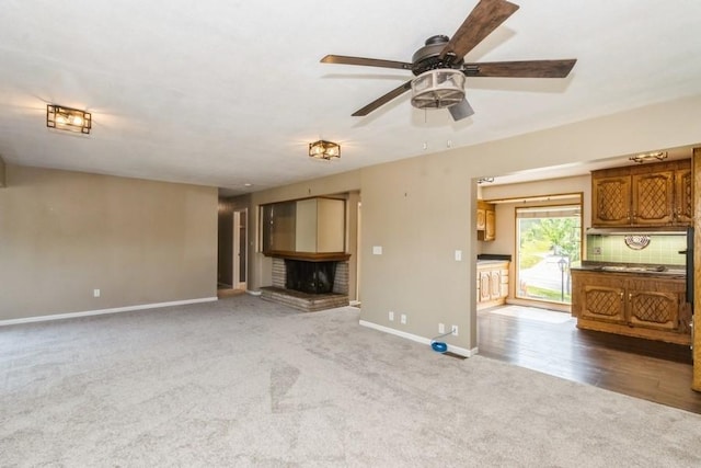 2175 Chandler St SW, Cedar Rapids, IA 52404 - unfurnished living room with carpet floors, a brick fireplace, and ceiling fan