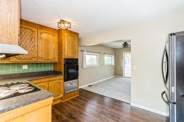 2175 Chandler St SW, Cedar Rapids, IA 52404 - kitchen with oven, freestanding refrigerator, stovetop, tasteful backsplash, and dark countertops