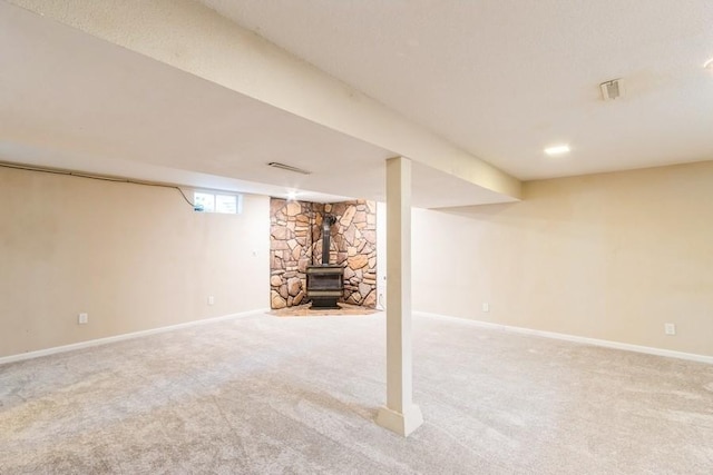 2175 Chandler St SW, Cedar Rapids, IA 52404 - basement featuring a wood stove and carpet flooring