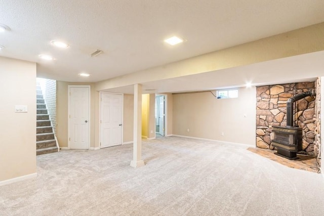 2175 Chandler St SW, Cedar Rapids, IA 52404 - basement with a wood stove, carpet, and stairway