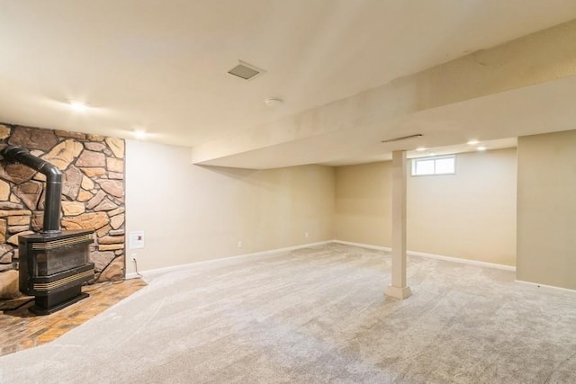 2175 Chandler St SW, Cedar Rapids, IA 52404 - below grade area with a wood stove and carpet flooring