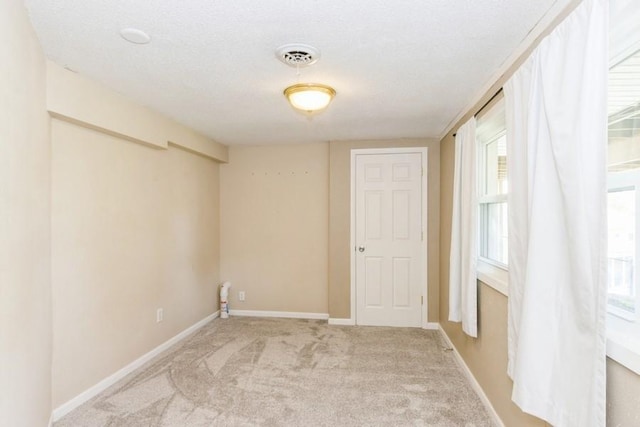 2175 Chandler St SW, Cedar Rapids, IA 52404 - spare room with light colored carpet, plenty of natural light, and a textured ceiling