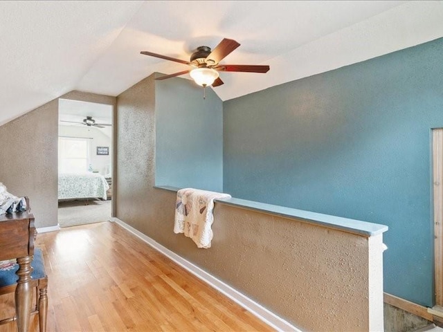 1418 8th St NW, Cedar Rapids, IA 52405 - hall with wood finished floors, lofted ceiling, and a textured wall