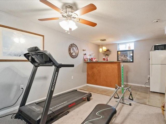 1418 8th St NW, Cedar Rapids, IA 52405 - exercise room with tile patterned flooring, a textured ceiling, and a ceiling fan