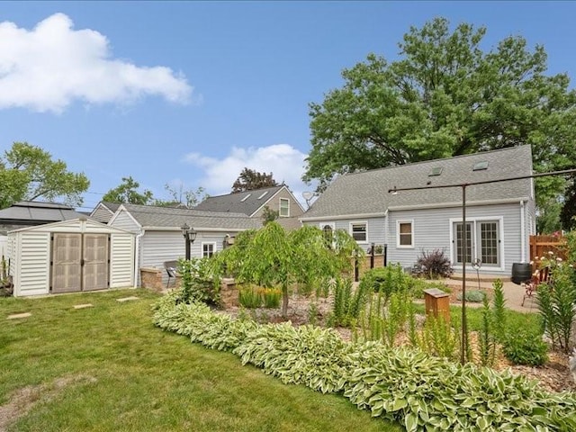 1418 8th St NW, Cedar Rapids, IA 52405 - view of grassy yard featuring a storage unit and a patio
