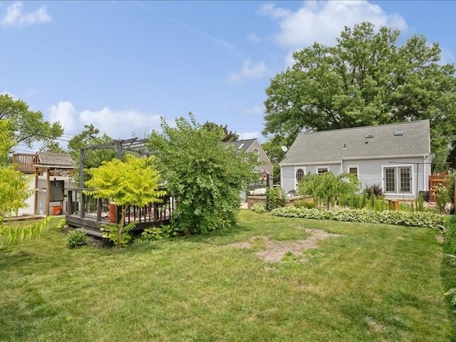 1418 8th St NW, Cedar Rapids, IA 52405 - view of grassy yard with a wooden deck and a pergola
