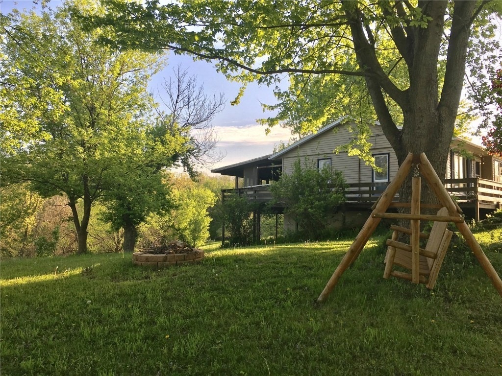 420 Knoll St, Anamosa, IA 52205 - view of green lawn with a deck