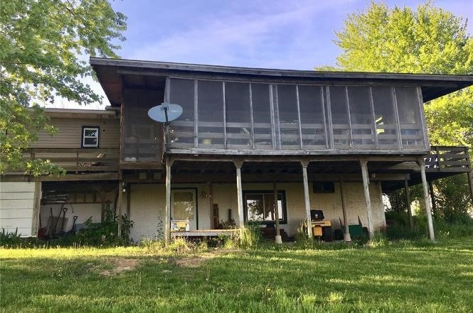 420 Knoll St, Anamosa, IA 52205 - back of property with a sunroom and a lawn