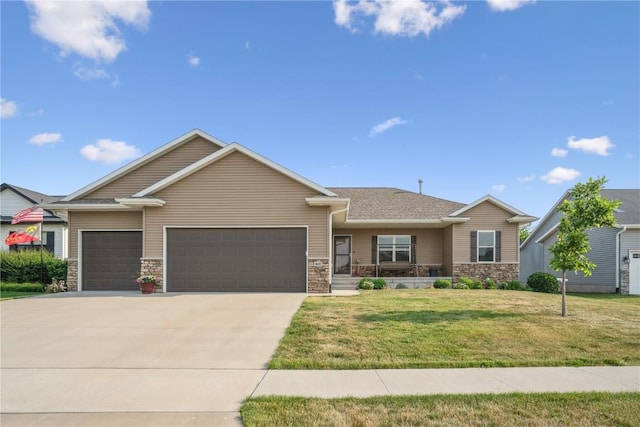 1602 Bridge Creek Ct, Marion, IA 52302 - view of front facade with a garage, a front yard, concrete driveway, stone siding, and a porch