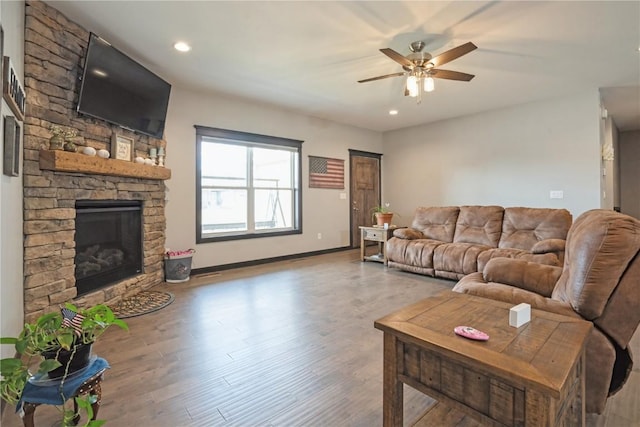 1602 Bridge Creek Ct, Marion, IA 52302 - living room featuring a stone fireplace, ceiling fan, wood finished floors, and recessed lighting