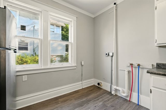 216 15th St NE, Cedar Rapids, IA 52402 - laundry room featuring dark wood-type flooring, washer hookup, cabinet space, and ornamental molding