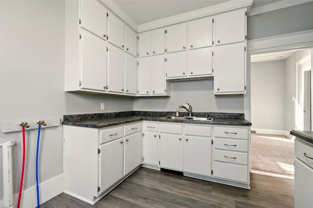 216 15th St NE, Cedar Rapids, IA 52402 - kitchen featuring dark wood-style flooring, dark countertops, and white cabinets