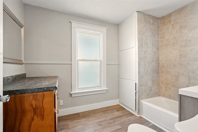 216 15th St NE, Cedar Rapids, IA 52402 - full bathroom with vanity, wood finished floors, and washtub / shower combination