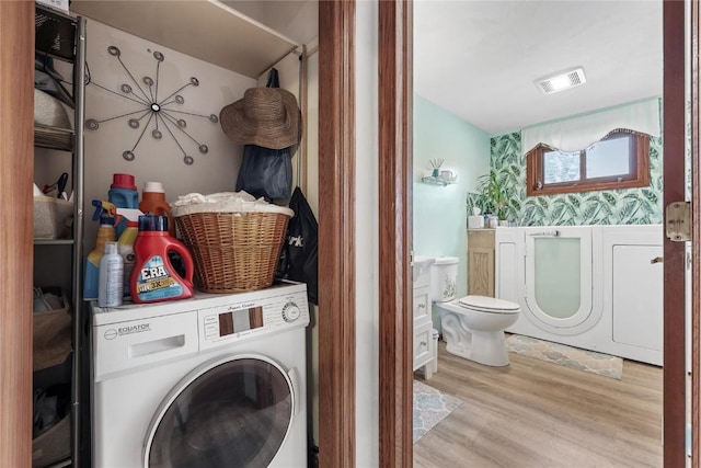 2145 Coldstream Ave NE, Cedar Rapids, IA 52402 - laundry room with washer / clothes dryer and wood finished floors