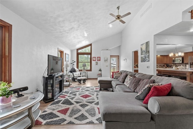 2145 Coldstream Ave NE, Cedar Rapids, IA 52402 - living area featuring vaulted ceiling, wood finished floors, and ceiling fan