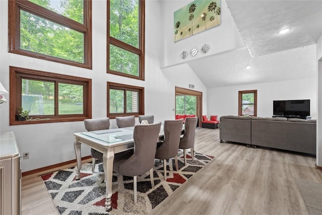 2145 Coldstream Ave NE, Cedar Rapids, IA 52402 - dining room featuring light wood-style flooring and a towering ceiling
