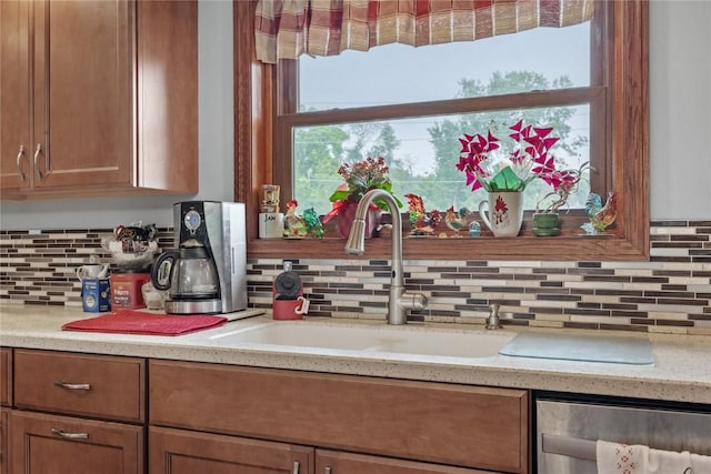 2145 Coldstream Ave NE, Cedar Rapids, IA 52402 - kitchen with dishwashing machine, tasteful backsplash, and brown cabinetry