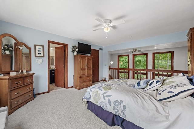 2145 Coldstream Ave NE, Cedar Rapids, IA 52402 - bedroom with light carpet, connected bathroom, and a ceiling fan